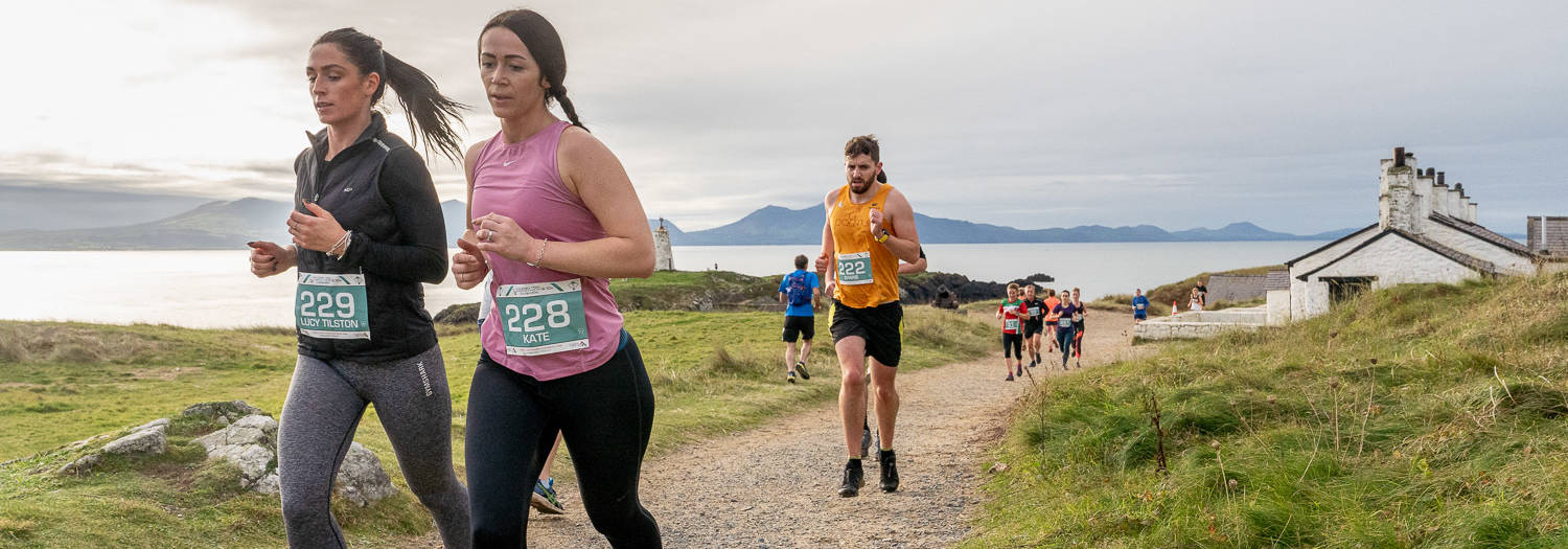 Runners on Ynys Llanddwyn Island