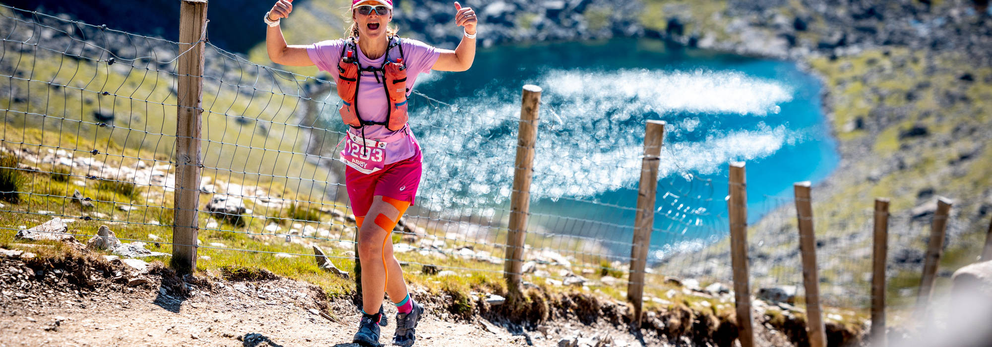 Runner ascending Snowdon with Llyn Du'r Arddu in the background